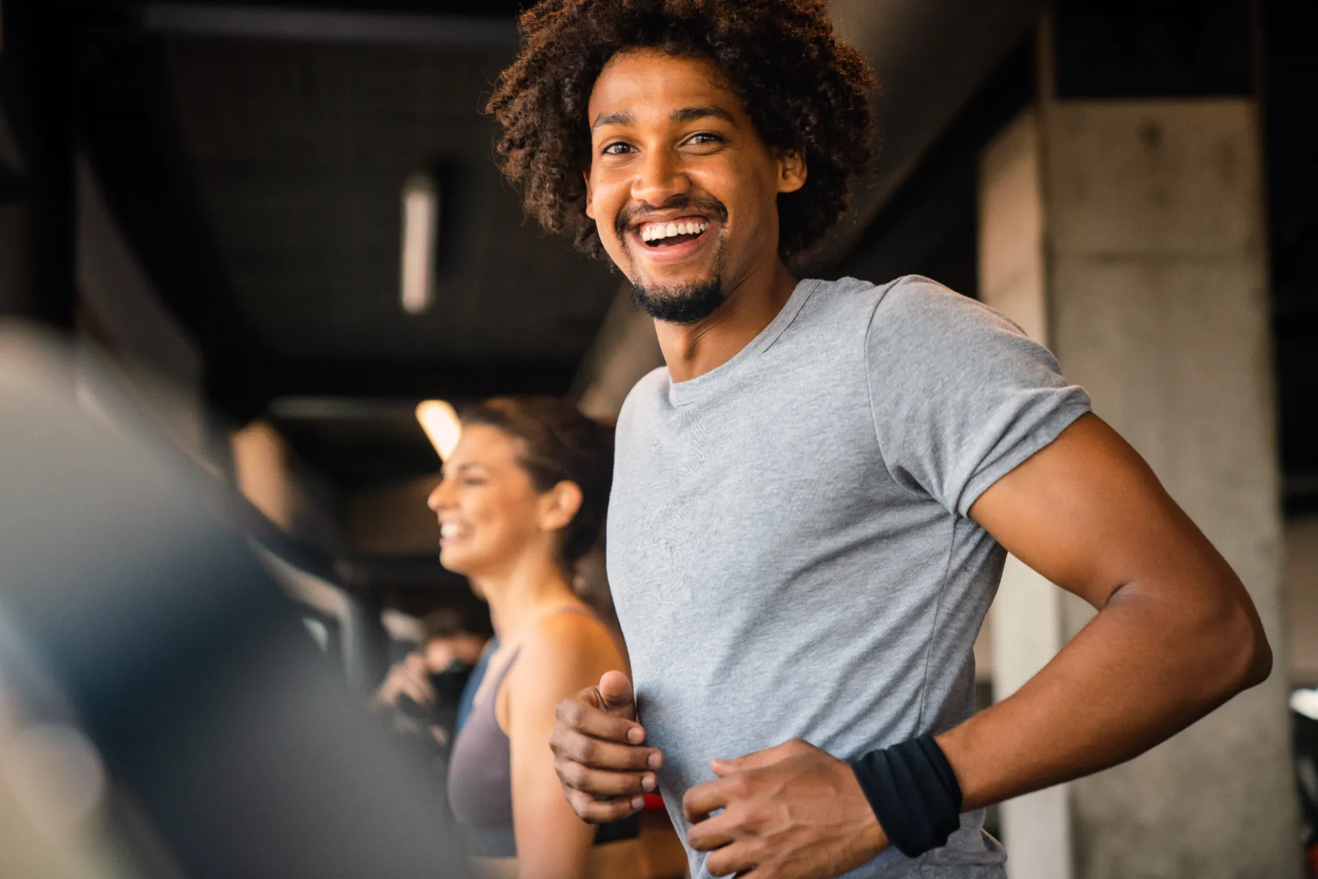 fit man exercising at the gym on a machine utc